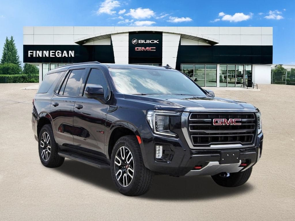 2024 GMC Yukon AT4 in Midnight Blue Metallic — front three-quarter view
